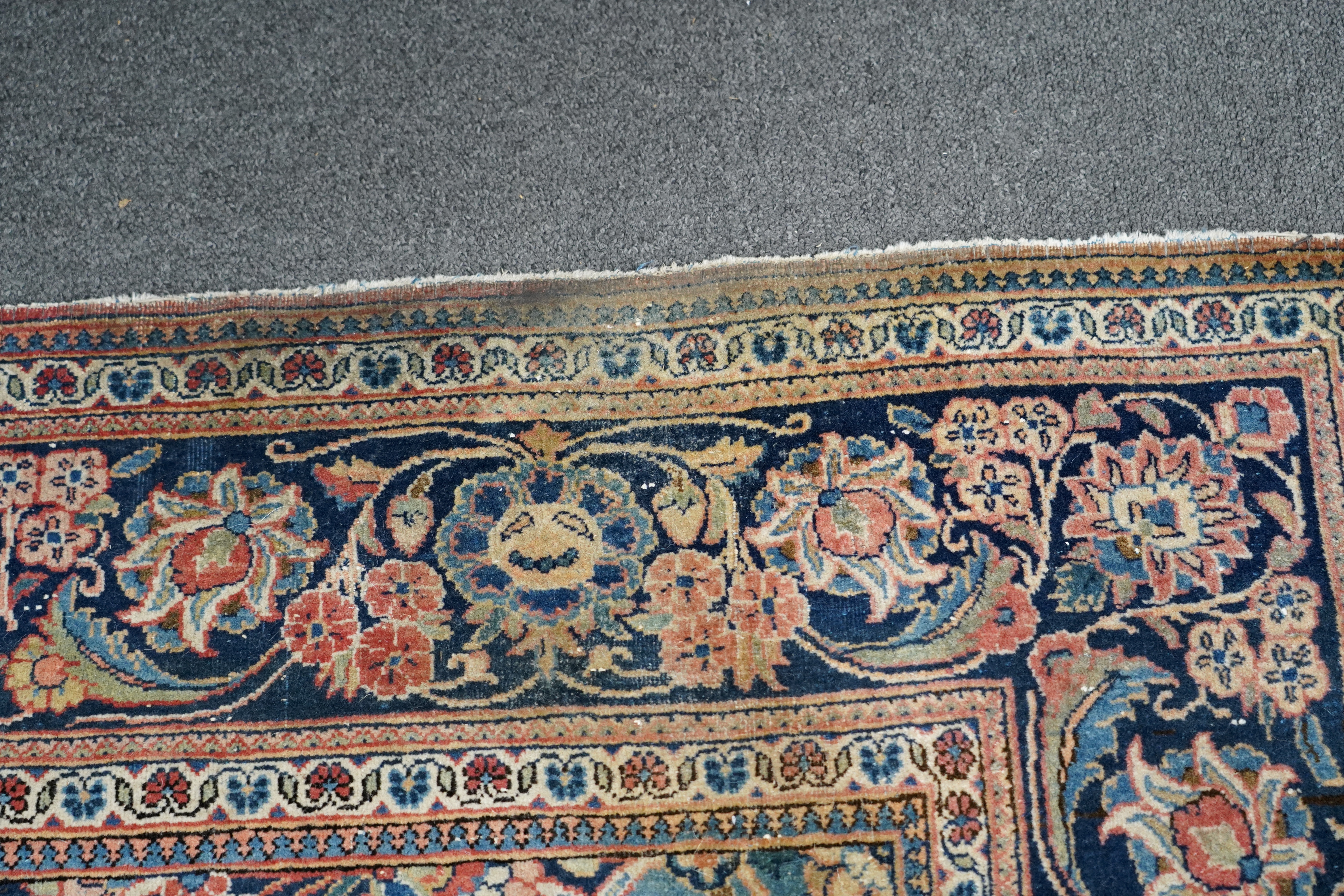 A pair of antique Tabriz brick red ground rugs, 200 x 136cm. Condition - fair